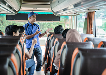 A bus driver chats with passengers