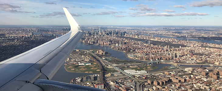 An airplane flies over NYC