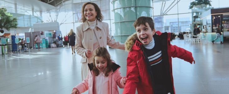 a happy family smiles greeting family at the airport