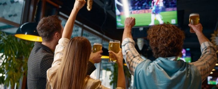 sports fans cheer at a sports bar