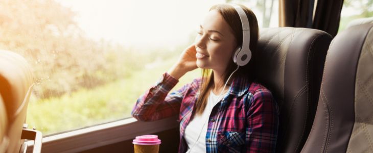 a bus passenger listening to music with headphones
