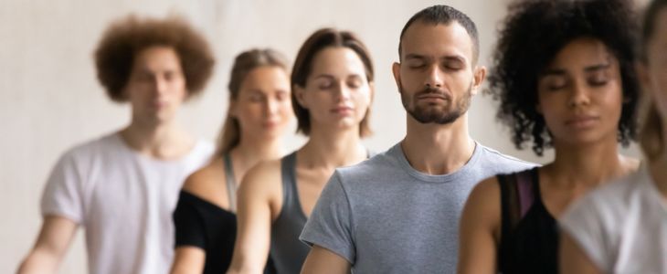 a group of people do yoga at a retreat
