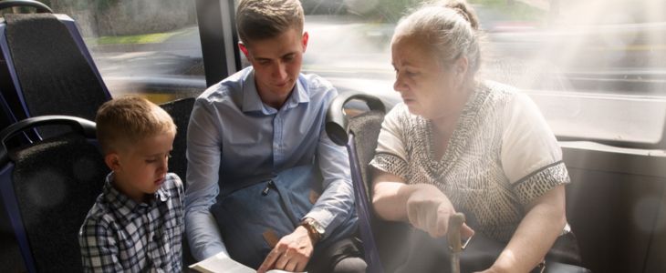 a family sit together on a shuttle bus