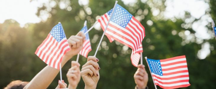 people waving small american flags