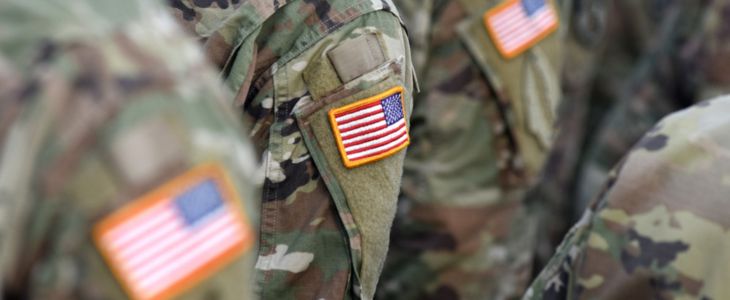 a line-up of soldiers showing their american flag patches
